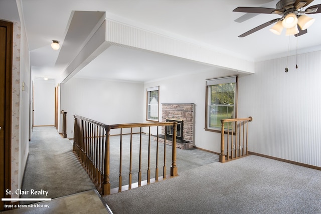 hall with ornamental molding and light carpet