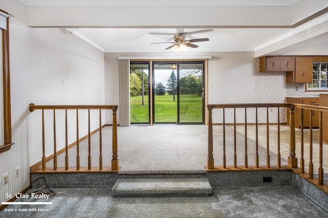 interior space with ceiling fan and carpet flooring