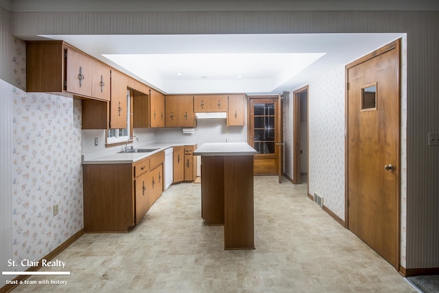 kitchen featuring sink, a center island, and dishwasher