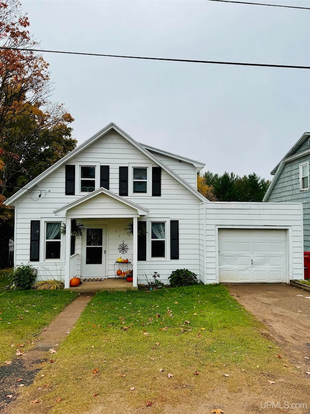 view of front of house with a garage, a front yard, and covered porch