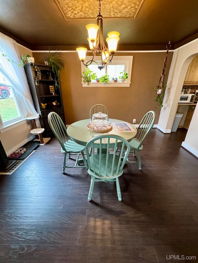 dining area with a chandelier and dark hardwood / wood-style floors