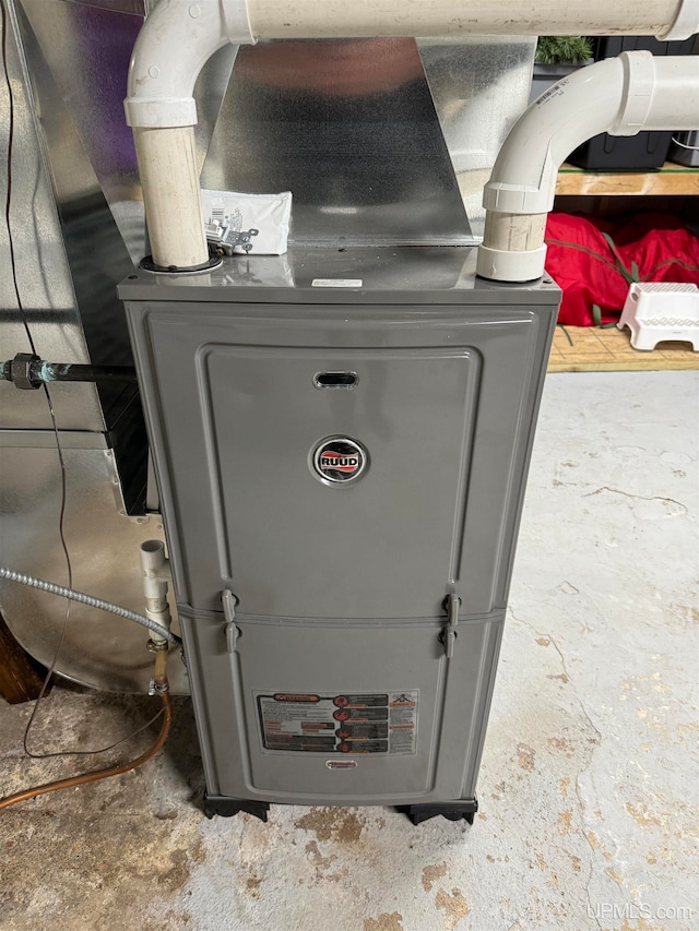 utility room featuring heating unit