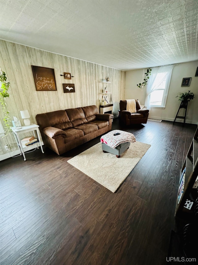 living room with a textured ceiling and dark wood-type flooring