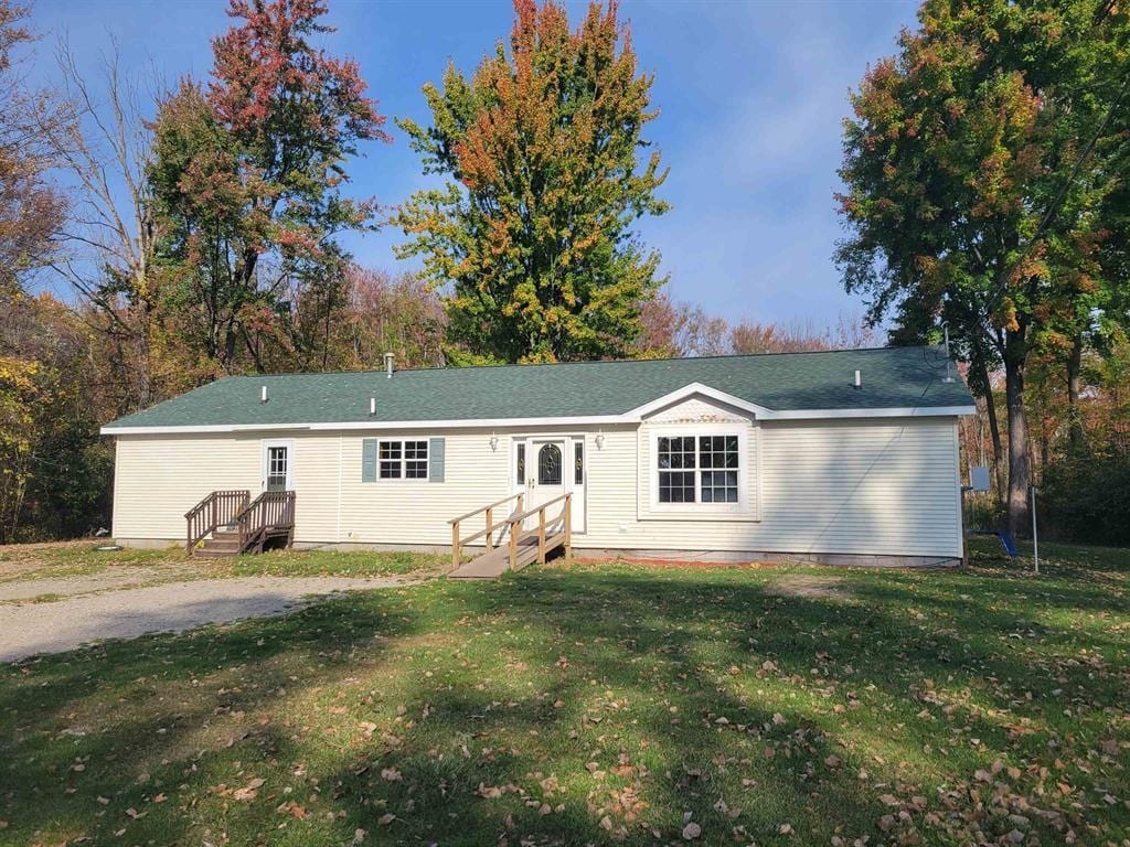 rear view of property featuring a yard