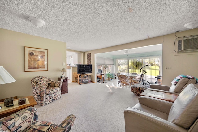 living room featuring a textured ceiling, a wall mounted AC, carpet flooring, and ceiling fan