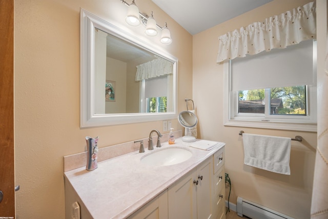 bathroom featuring vanity, a baseboard heating unit, and a wealth of natural light