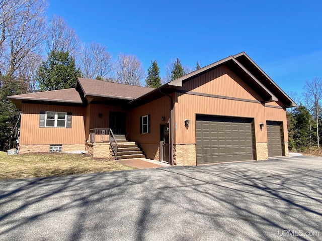 single story home featuring an attached garage and driveway