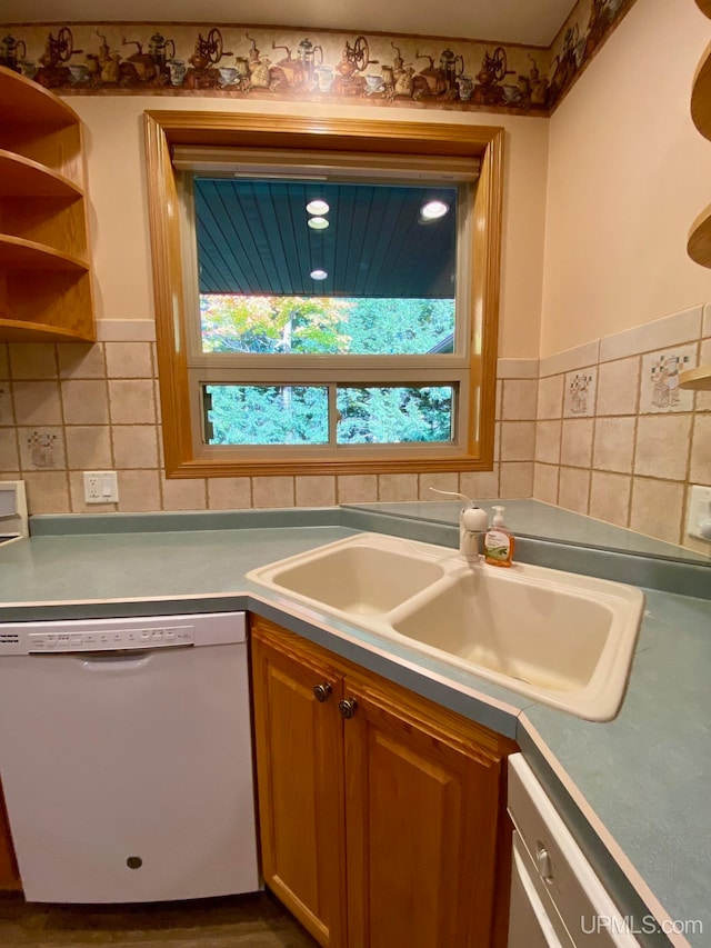 kitchen with sink, dishwasher, dishwashing machine, and tasteful backsplash