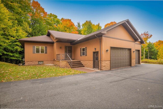 737 Grove St, Marquette, MI 49855 - ranch-style house with an attached garage, a shingled roof, and driveway