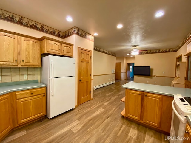 kitchen with decorative backsplash, a baseboard heating unit, ceiling fan, light hardwood / wood-style floors, and white appliances