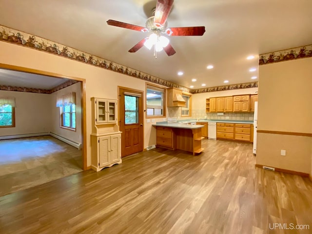 kitchen featuring white appliances, backsplash, light hardwood / wood-style floors, ceiling fan, and custom exhaust hood