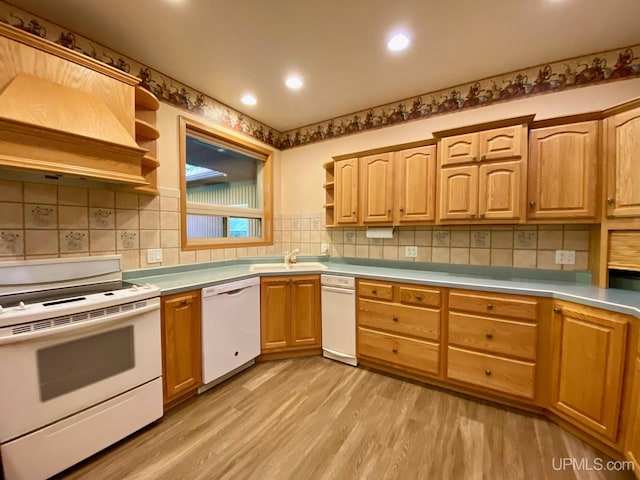 kitchen with a sink, light wood-type flooring, white appliances, open shelves, and light countertops