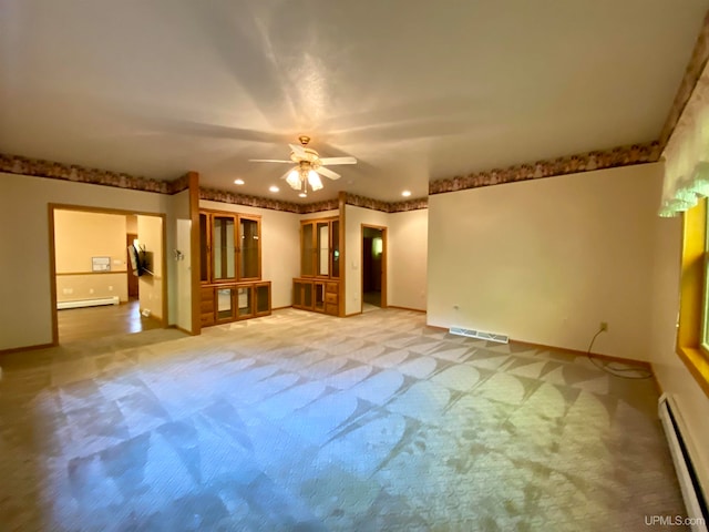 unfurnished living room featuring a baseboard radiator, carpet floors, and ceiling fan