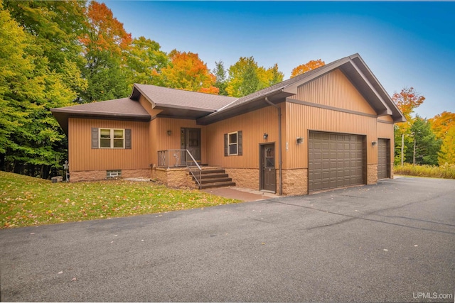 ranch-style house with a front yard and a garage