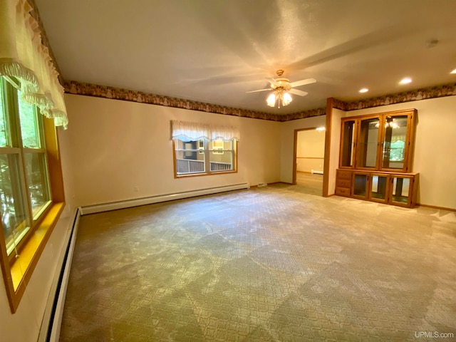 unfurnished living room featuring carpet flooring, a baseboard radiator, and ceiling fan