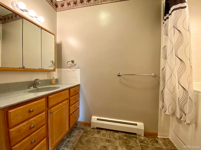 bathroom featuring vanity, a baseboard radiator, and curtained shower