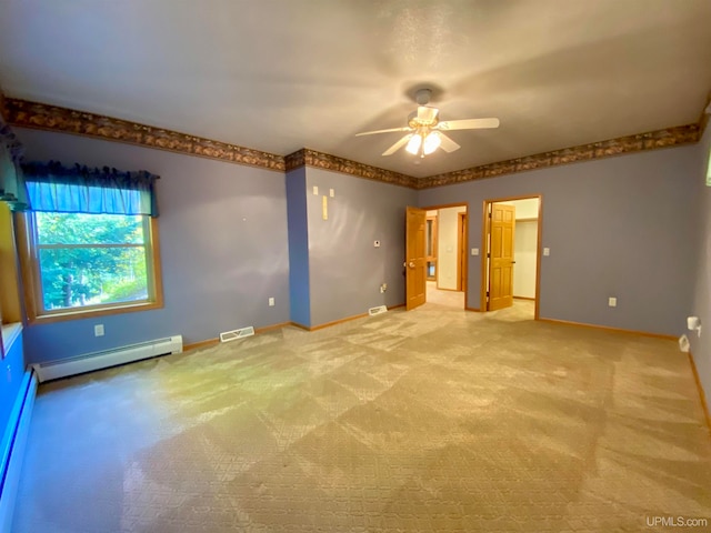 spare room featuring ceiling fan, light carpet, and a baseboard heating unit