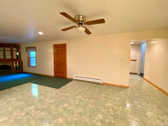 unfurnished living room with a baseboard heating unit and ceiling fan