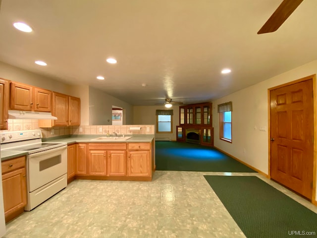 kitchen featuring tasteful backsplash, sink, kitchen peninsula, ceiling fan, and white range with electric stovetop