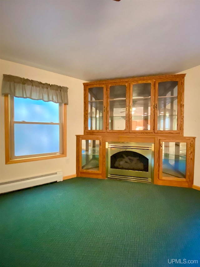 unfurnished living room with baseboard heating and dark carpet