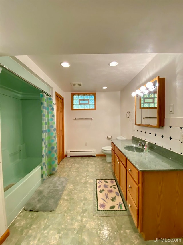 full bathroom with vanity, toilet, a baseboard heating unit, and shower / tub combo with curtain