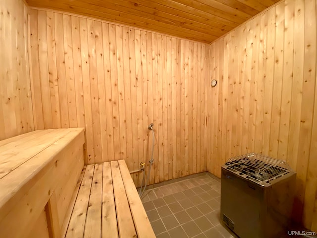 view of sauna / steam room featuring wood ceiling, tile patterned floors, and wooden walls