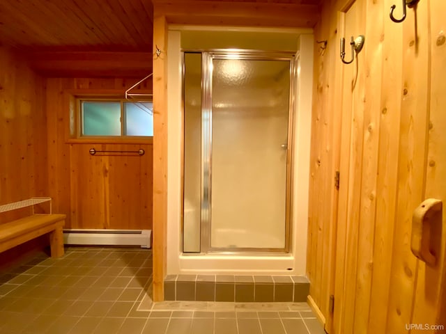 bathroom with baseboard heating, wooden walls, a shower with door, and wooden ceiling