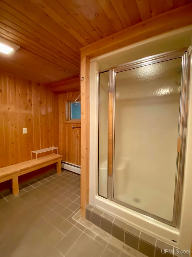 bathroom with tile patterned floors, wooden ceiling, an enclosed shower, and wood walls