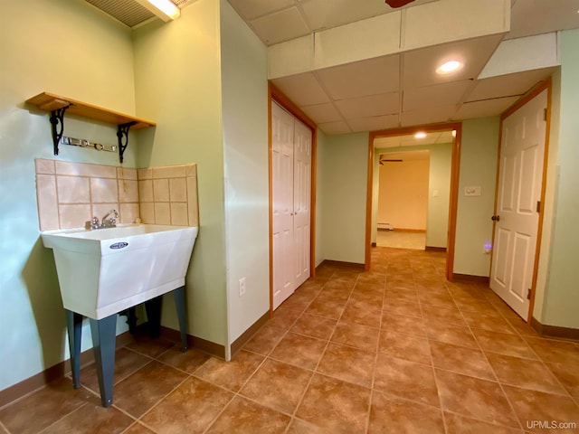 laundry area featuring light tile patterned flooring and a baseboard radiator