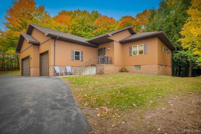 view of front of property with a front lawn and a garage