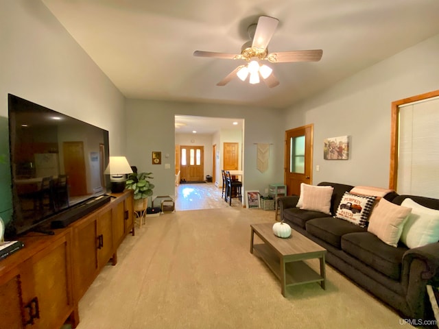 carpeted living room featuring ceiling fan