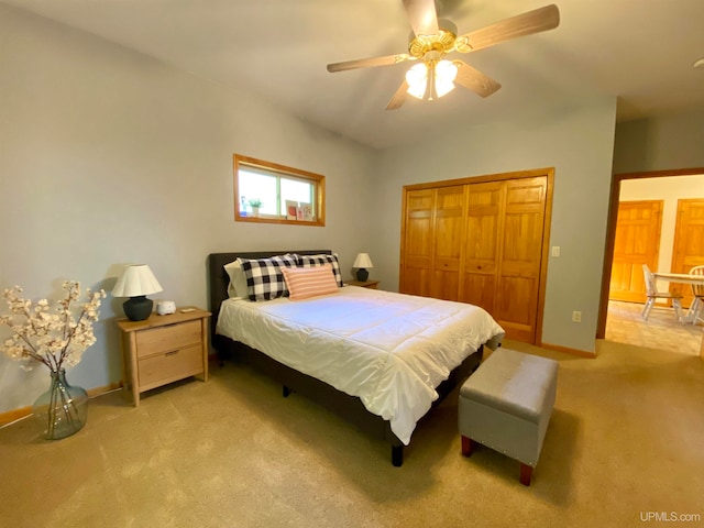 bedroom featuring a closet, ceiling fan, and light carpet