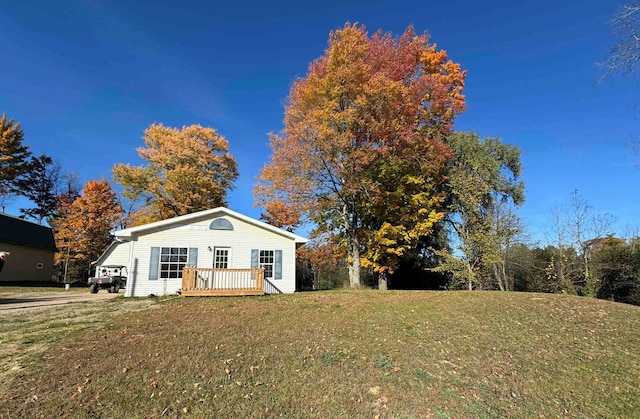 3256 Hilts Rd, Gladwin, MI 48624 - view of front facade featuring a front yard and a deck