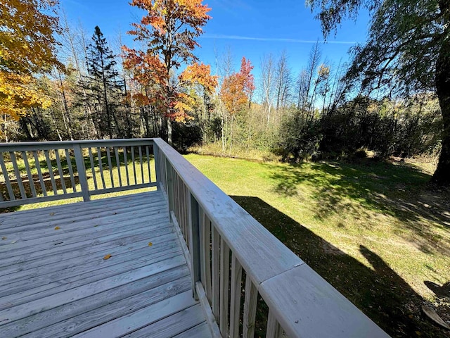 wooden terrace featuring a yard