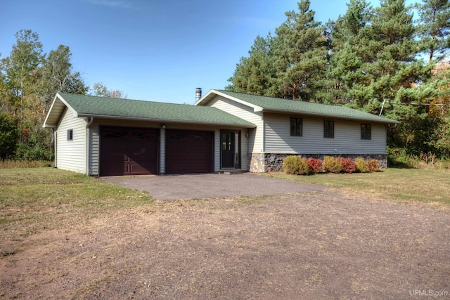 view of front of house with a garage and a front yard