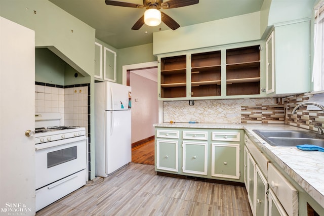 kitchen featuring tasteful backsplash, sink, ceiling fan, and white appliances