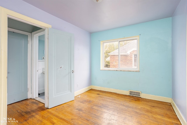 unfurnished bedroom with a closet and light wood-type flooring