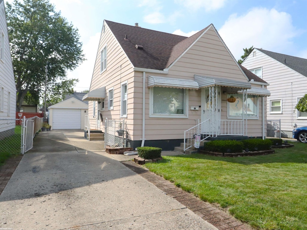 bungalow-style house featuring a front yard, an outbuilding, and a garage