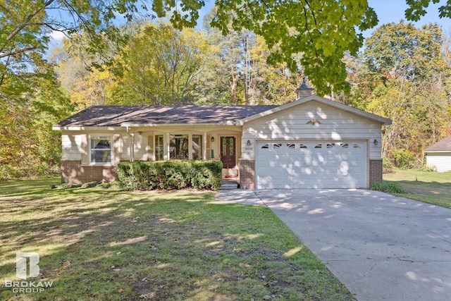 ranch-style house featuring covered porch, a garage, and a front lawn