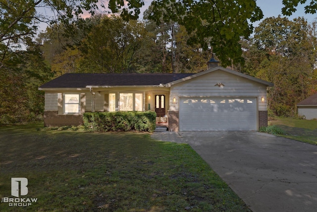 single story home featuring a yard and a garage