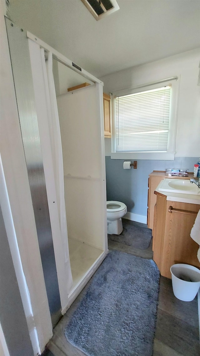 bathroom featuring vanity, toilet, a shower with curtain, and hardwood / wood-style floors