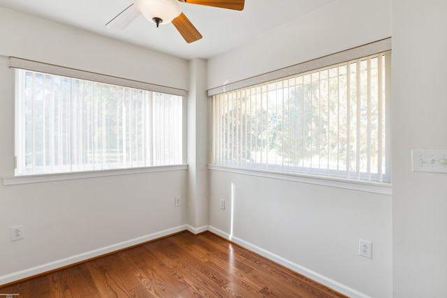 unfurnished room with ceiling fan, wood-type flooring, and plenty of natural light