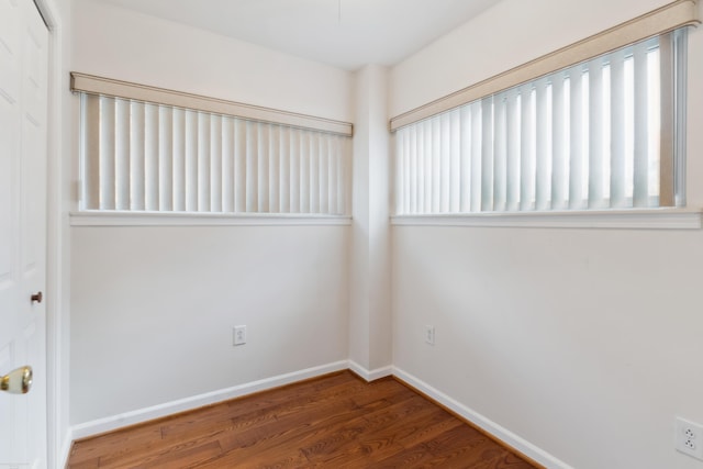 spare room with dark wood-type flooring