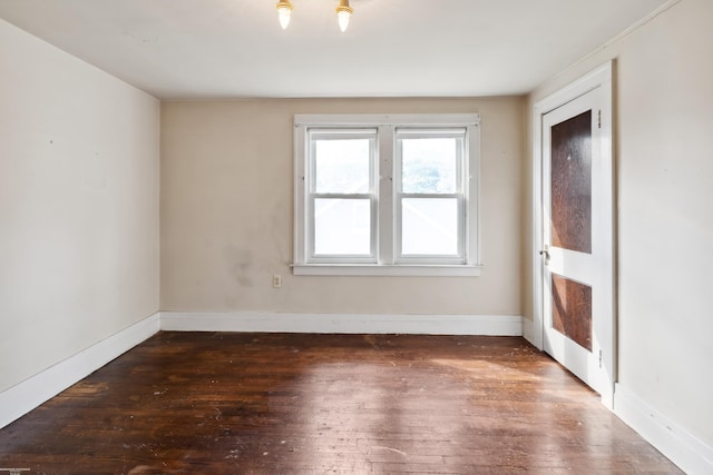 spare room with dark hardwood / wood-style floors