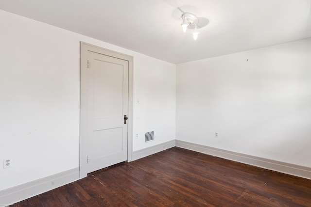 empty room featuring dark hardwood / wood-style flooring