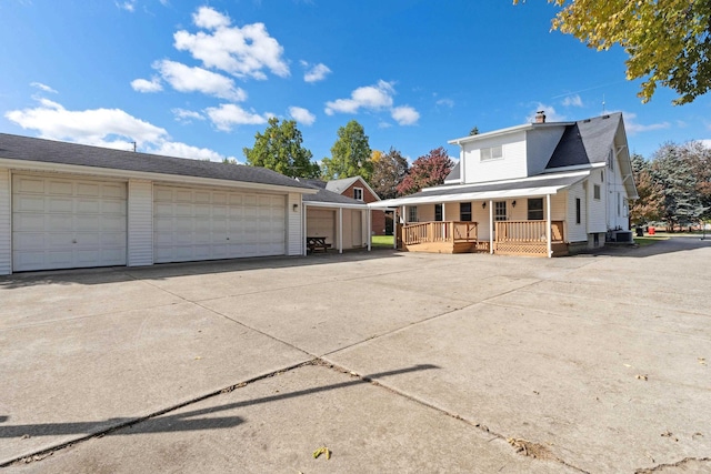 view of front of property featuring a garage and central AC unit