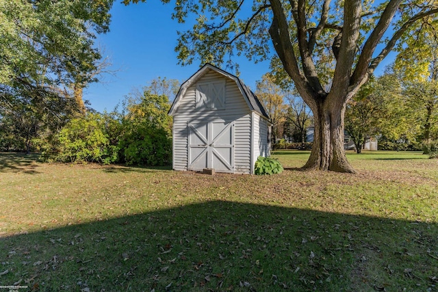 view of outbuilding with a yard