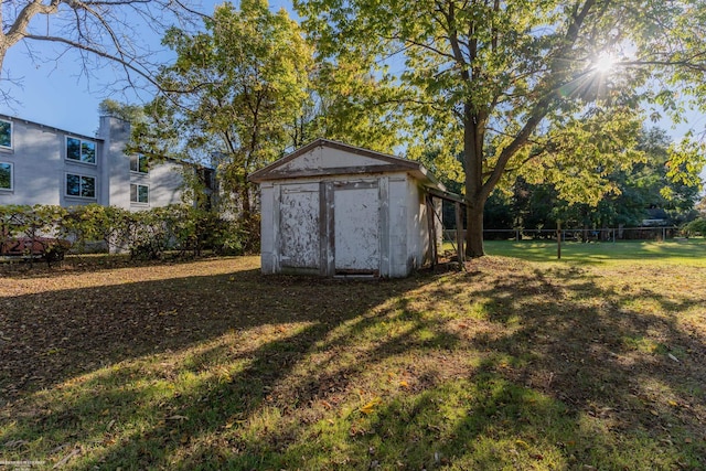 view of outbuilding with a yard