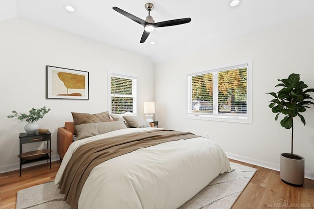 bedroom featuring ceiling fan, vaulted ceiling, and light wood-type flooring