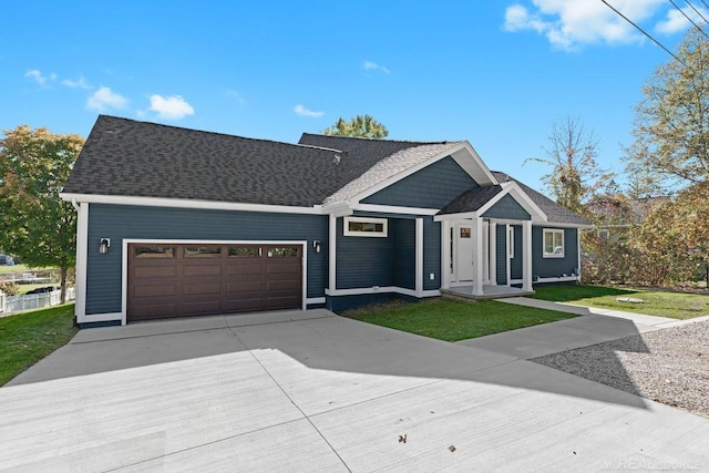 view of front of home featuring a front lawn and a garage